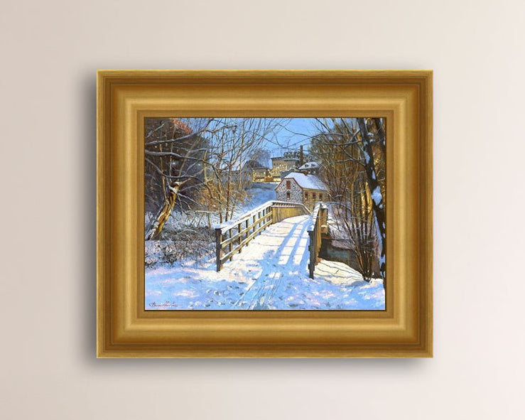 A framed canvas print featuring a Monocacy Bridge with snow on the ground, surrounded by trees and a historic Bethlehem building in the background.