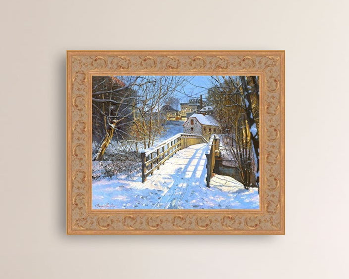A framed canvas print featuring a Monocacy Bridge with snow on the ground, surrounded by trees and a historic Bethlehem building in the background.