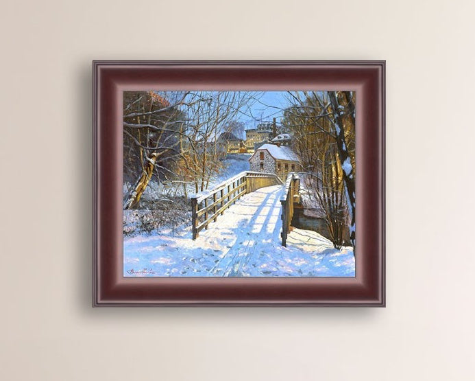 A framed canvas print featuring a Monocacy Bridge with snow on the ground, surrounded by trees and a historic Bethlehem building in the background.