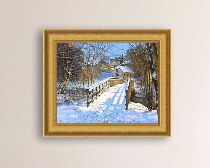 A framed canvas print featuring a Monocacy Bridge with snow on the ground, surrounded by trees and a historic Bethlehem building in the background.