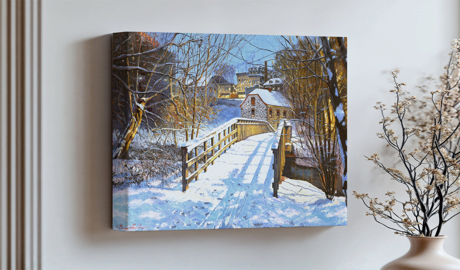 A framed canvas print featuring a Monocacy Bridge with snow on the ground, surrounded by trees and a historic Bethlehem building in the background.