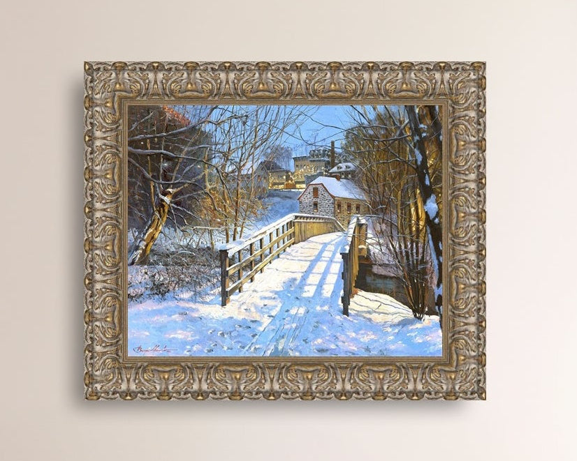 A framed canvas print featuring a Monocacy Bridge with snow on the ground, surrounded by trees and a historic Bethlehem building in the background.