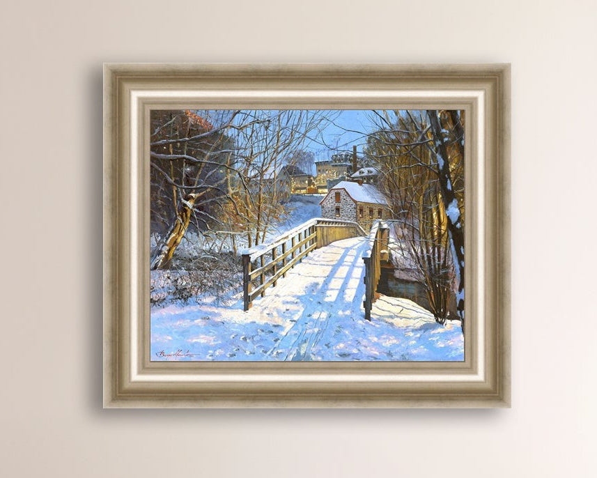 A framed canvas print featuring a Monocacy Bridge with snow on the ground, surrounded by trees and a historic Bethlehem building in the background.