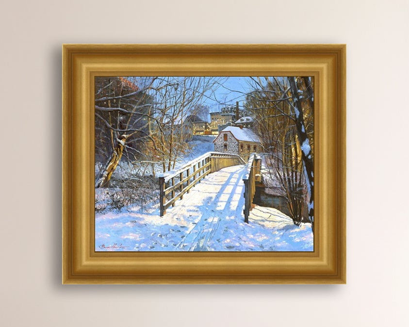 A framed canvas print featuring a Monocacy Bridge with snow on the ground, surrounded by trees and a historic Bethlehem building in the background.