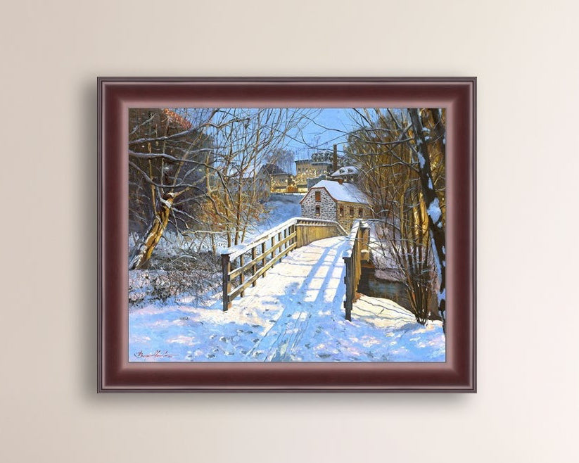 A framed canvas print featuring a Monocacy Bridge with snow on the ground, surrounded by trees and a historic Bethlehem building in the background.