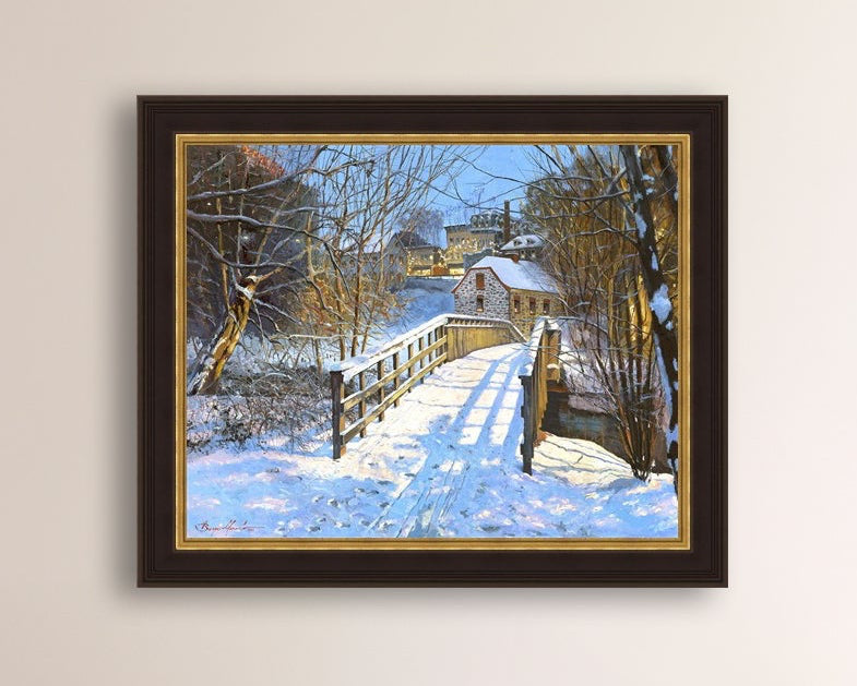 A framed canvas print featuring a Monocacy Bridge with snow on the ground, surrounded by trees and a historic Bethlehem building in the background.