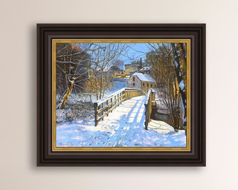 A framed canvas print featuring a Monocacy Bridge with snow on the ground, surrounded by trees and a historic Bethlehem building in the background.