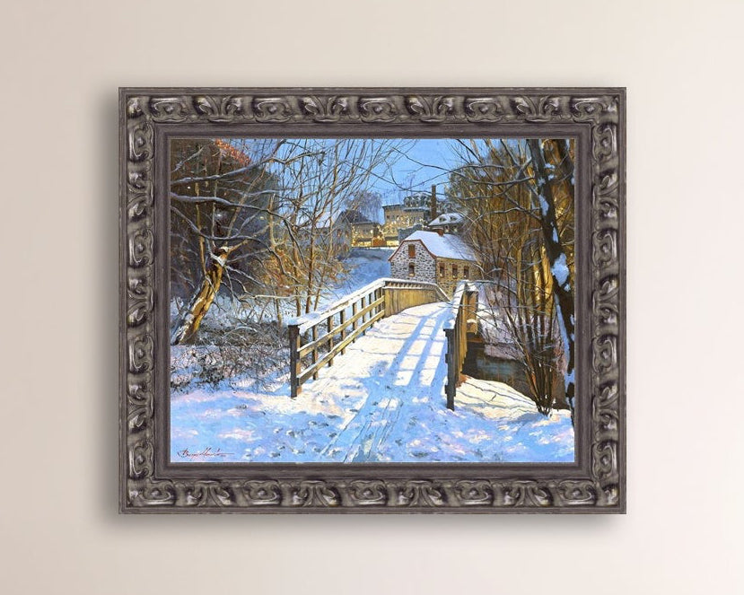 A framed canvas print featuring a Monocacy Bridge with snow on the ground, surrounded by trees and a historic Bethlehem building in the background.