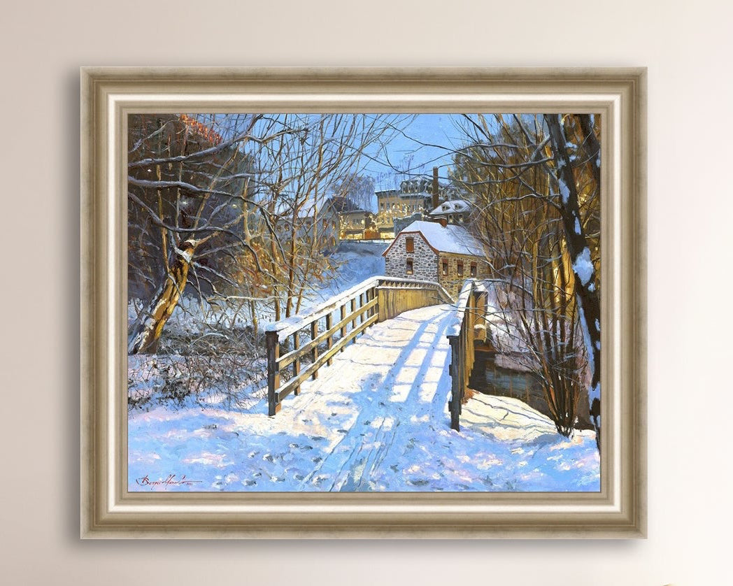 A framed canvas print featuring a Monocacy Bridge with snow on the ground, surrounded by trees and a historic Bethlehem building in the background.