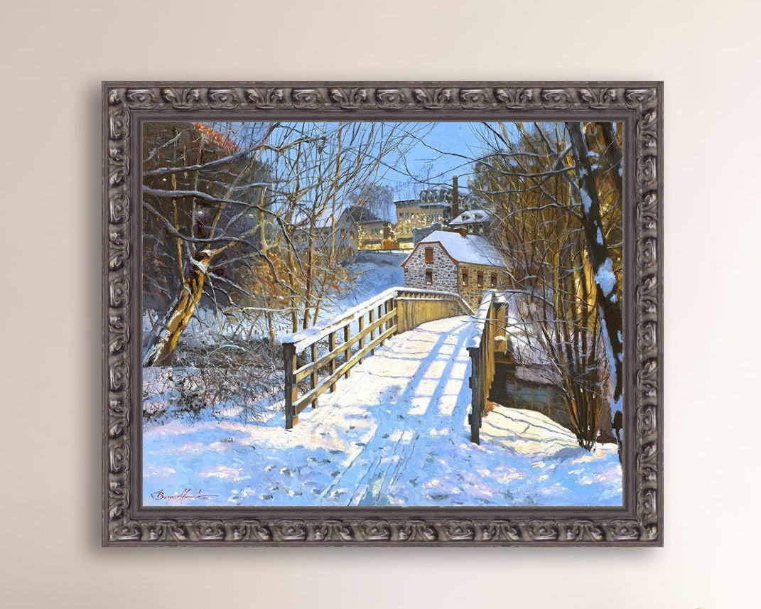 A framed canvas print featuring a Monocacy Bridge with snow on the ground, surrounded by trees and a historic Bethlehem building in the background.
