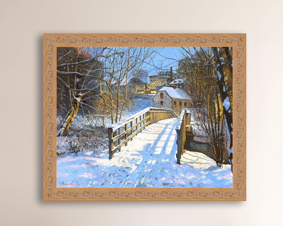 A framed canvas print featuring a Monocacy Bridge with snow on the ground, surrounded by trees and a historic Bethlehem building in the background.