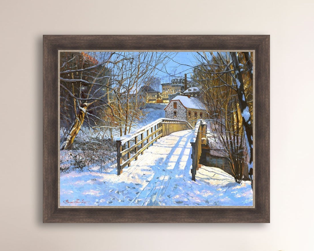 A framed canvas print featuring a Monocacy Bridge with snow on the ground, surrounded by trees and a historic Bethlehem building in the background.