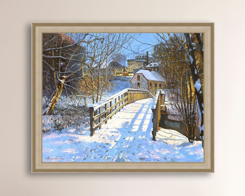 A framed canvas print featuring a Monocacy Bridge with snow on the ground, surrounded by trees and a historic Bethlehem building in the background.