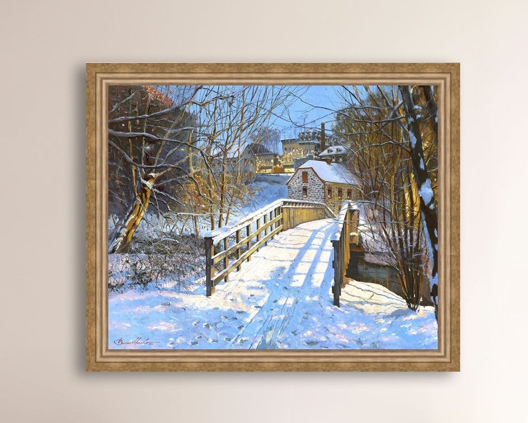 A framed canvas print featuring a Monocacy Bridge with snow on the ground, surrounded by trees and a historic Bethlehem building in the background.