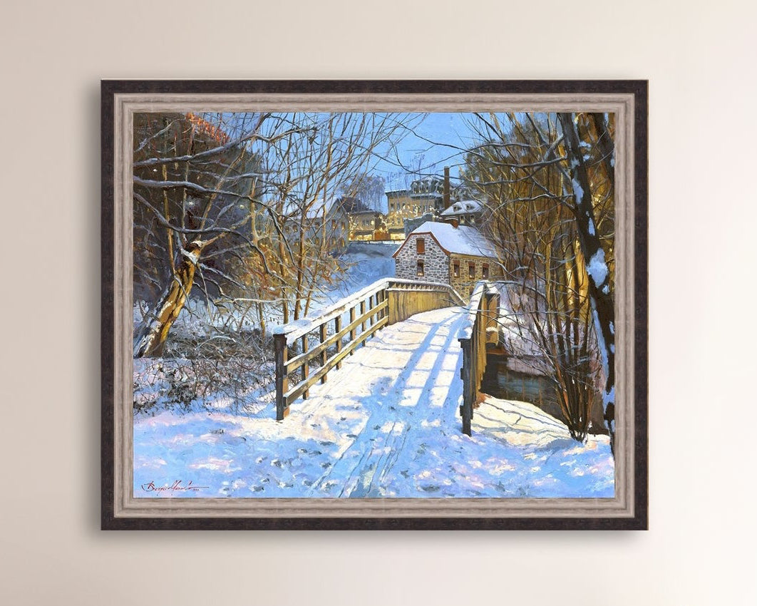 A framed canvas print featuring a Monocacy Bridge with snow on the ground, surrounded by trees and a historic Bethlehem building in the background.