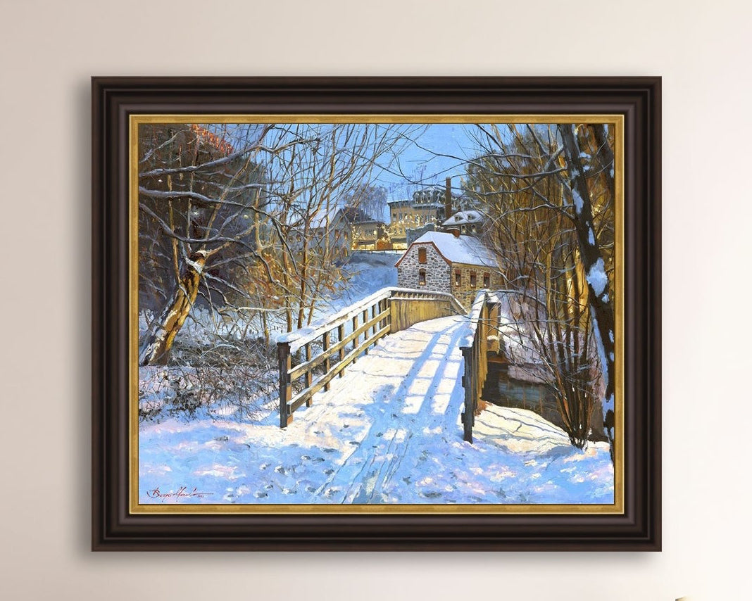 A framed canvas print featuring a Monocacy Bridge with snow on the ground, surrounded by trees and a historic Bethlehem building in the background.