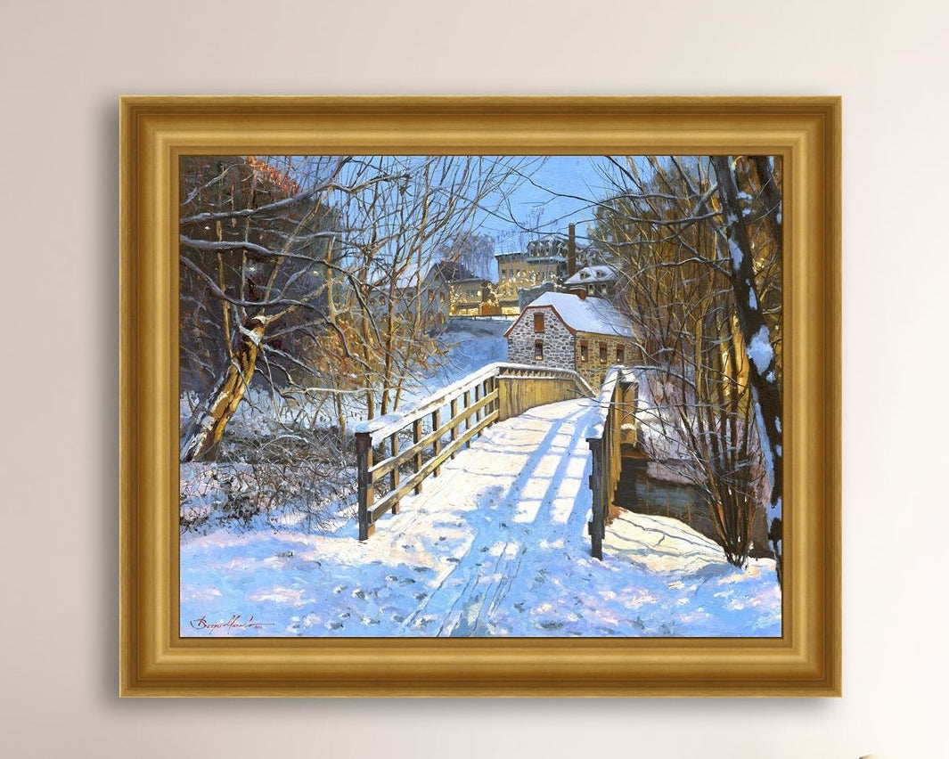 A framed canvas print featuring a Monocacy Bridge with snow on the ground, surrounded by trees and a historic Bethlehem building in the background.
