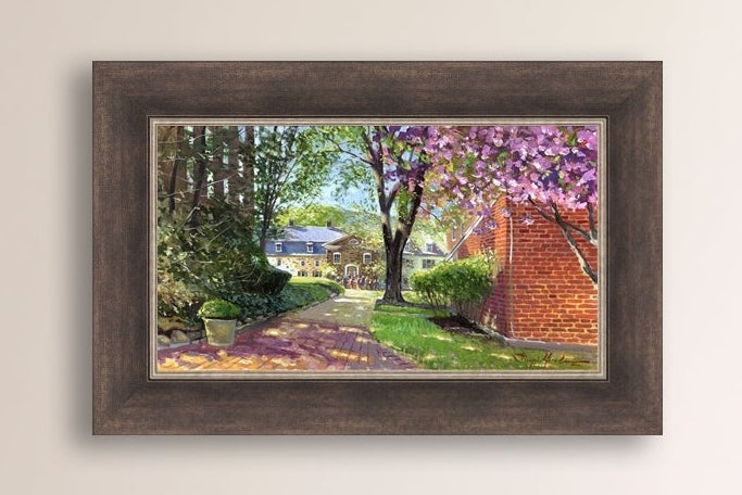A canvas print depicting a vibrant spring scene with a pathway, trees in bloom, and a historic Moravian Chapel in the background.