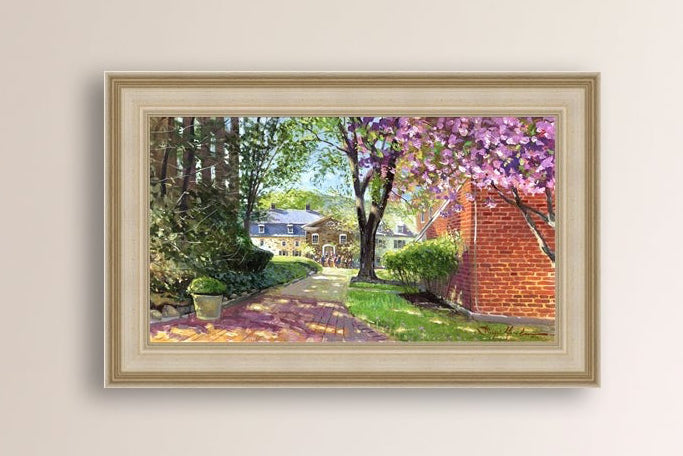 A canvas print depicting a vibrant spring scene with a pathway, trees in bloom, and a historic Moravian Chapel in the background.