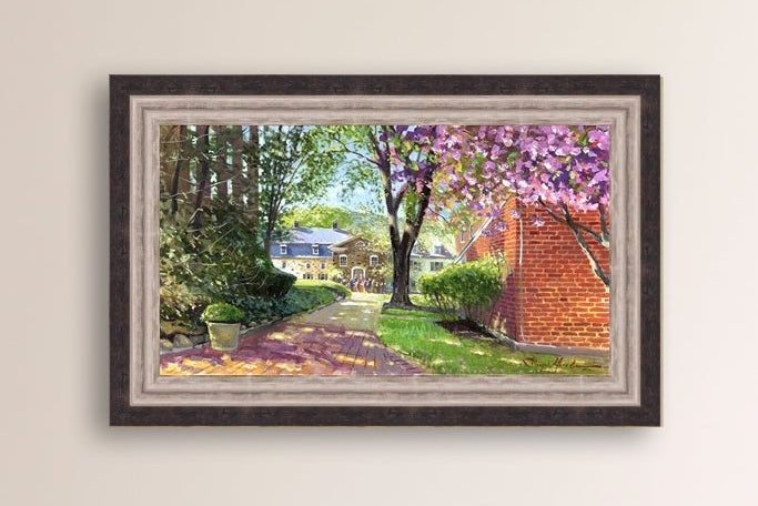 A canvas print depicting a vibrant spring scene with a pathway, trees in bloom, and a historic Moravian Chapel in the background.