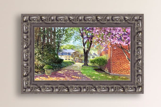 A canvas print depicting a vibrant spring scene with a pathway, trees in bloom, and a historic Moravian Chapel in the background.