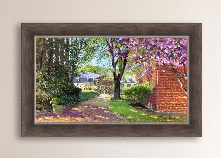 A canvas print depicting a vibrant spring scene with a pathway, trees in bloom, and a historic Moravian Chapel in the background.