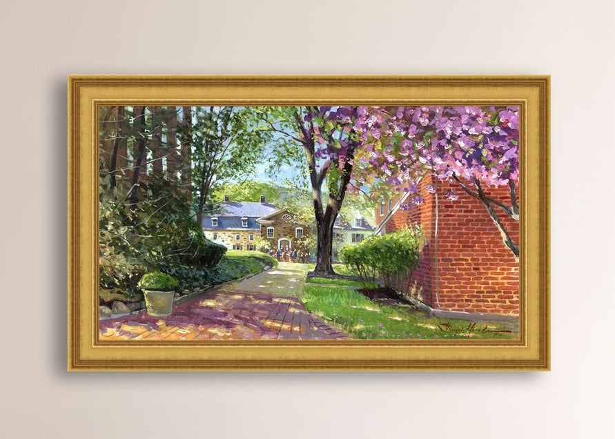 A canvas print depicting a vibrant spring scene with a pathway, trees in bloom, and a historic Moravian Chapel in the background.