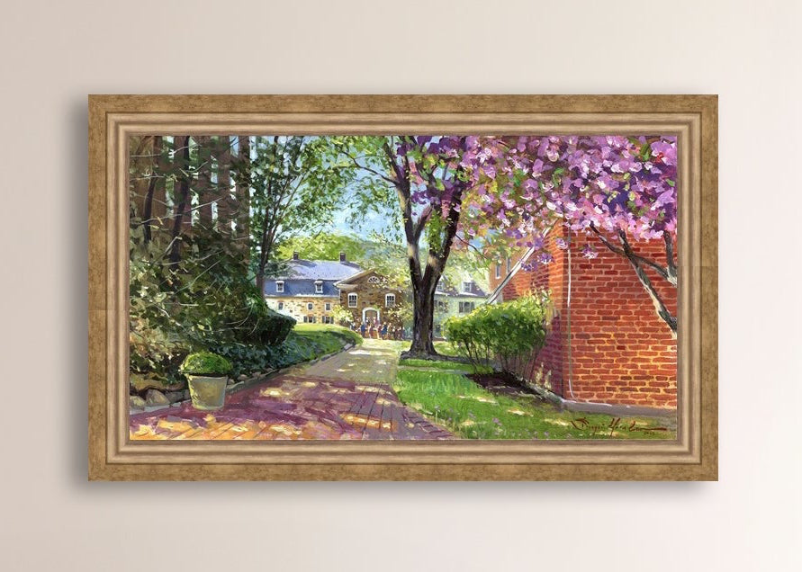 A canvas print depicting a vibrant spring scene with a pathway, trees in bloom, and a historic Moravian Chapel in the background.