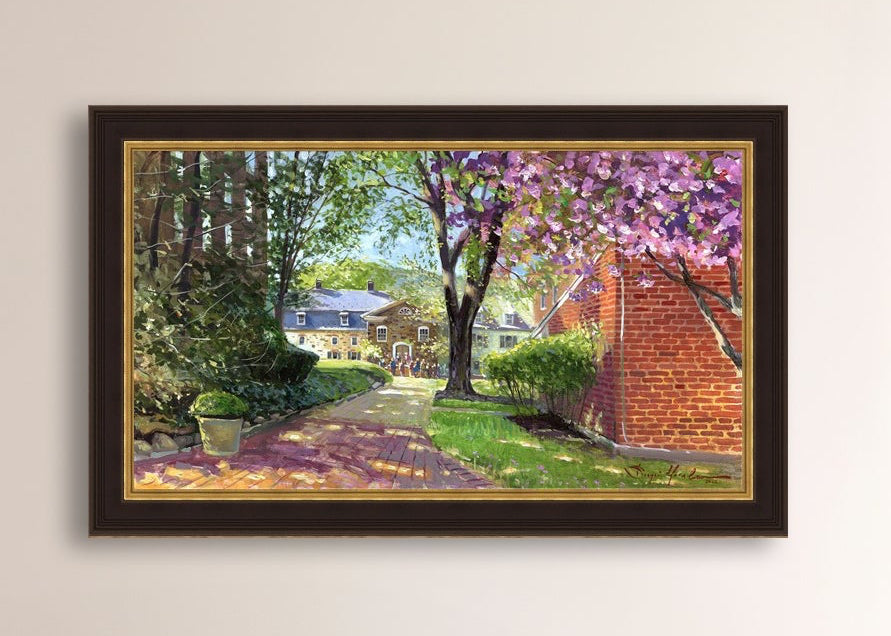 A canvas print depicting a vibrant spring scene with a pathway, trees in bloom, and a historic Moravian Chapel in the background.