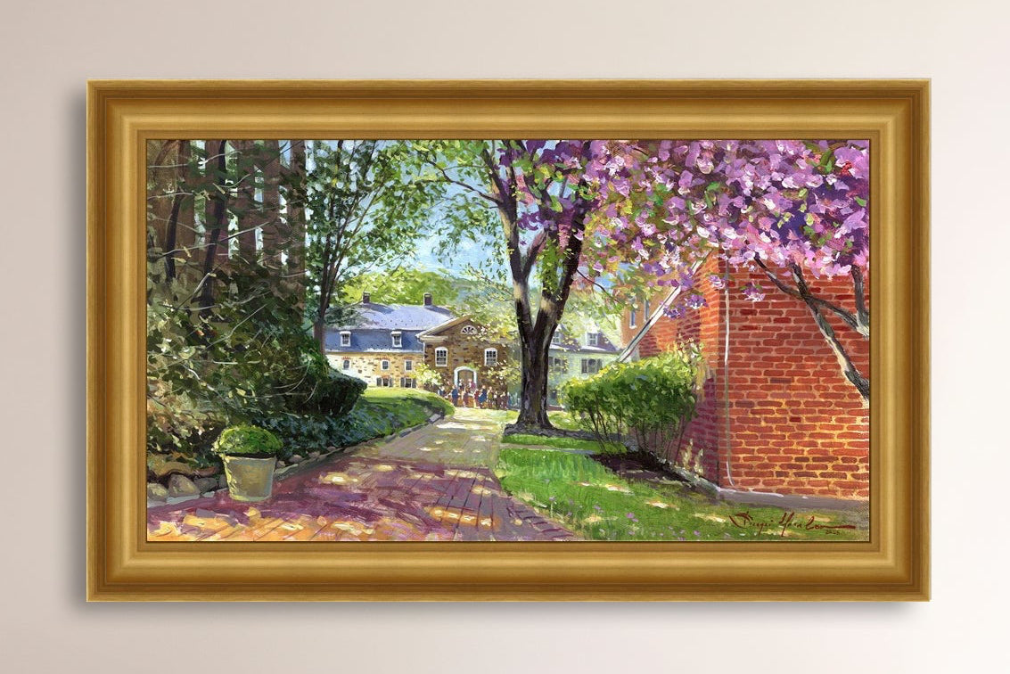 A canvas print depicting a vibrant spring scene with a pathway, trees in bloom, and a historic Moravian Chapel in the background.