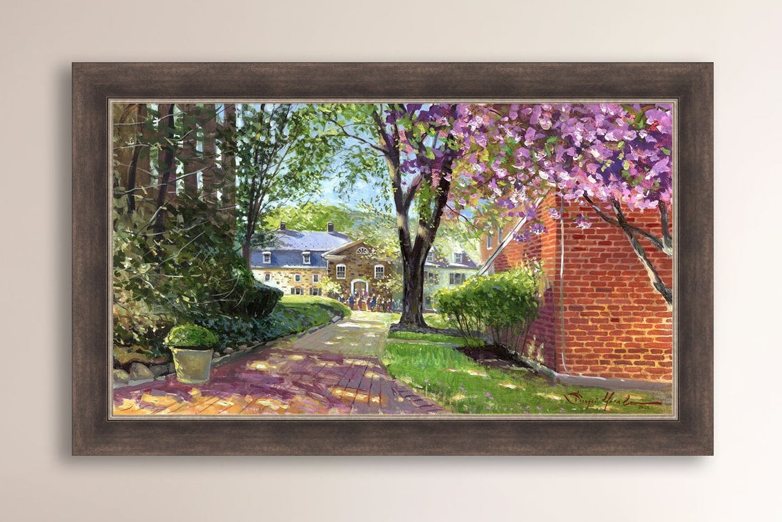 A canvas print depicting a vibrant spring scene with a pathway, trees in bloom, and a historic Moravian Chapel in the background.