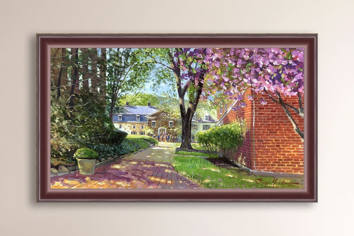 A canvas print depicting a vibrant spring scene with a pathway, trees in bloom, and a historic Moravian Chapel in the background.