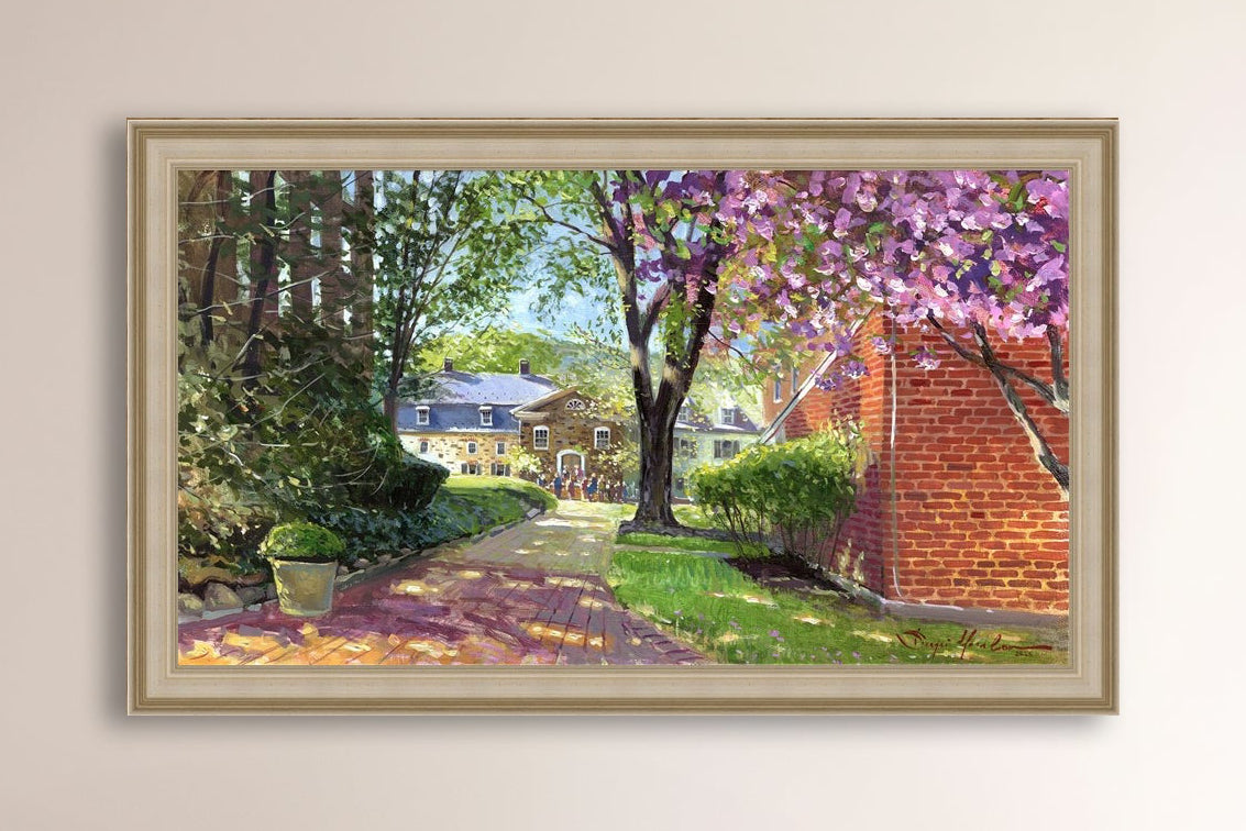 A canvas print depicting a vibrant spring scene with a pathway, trees in bloom, and a historic Moravian Chapel in the background.