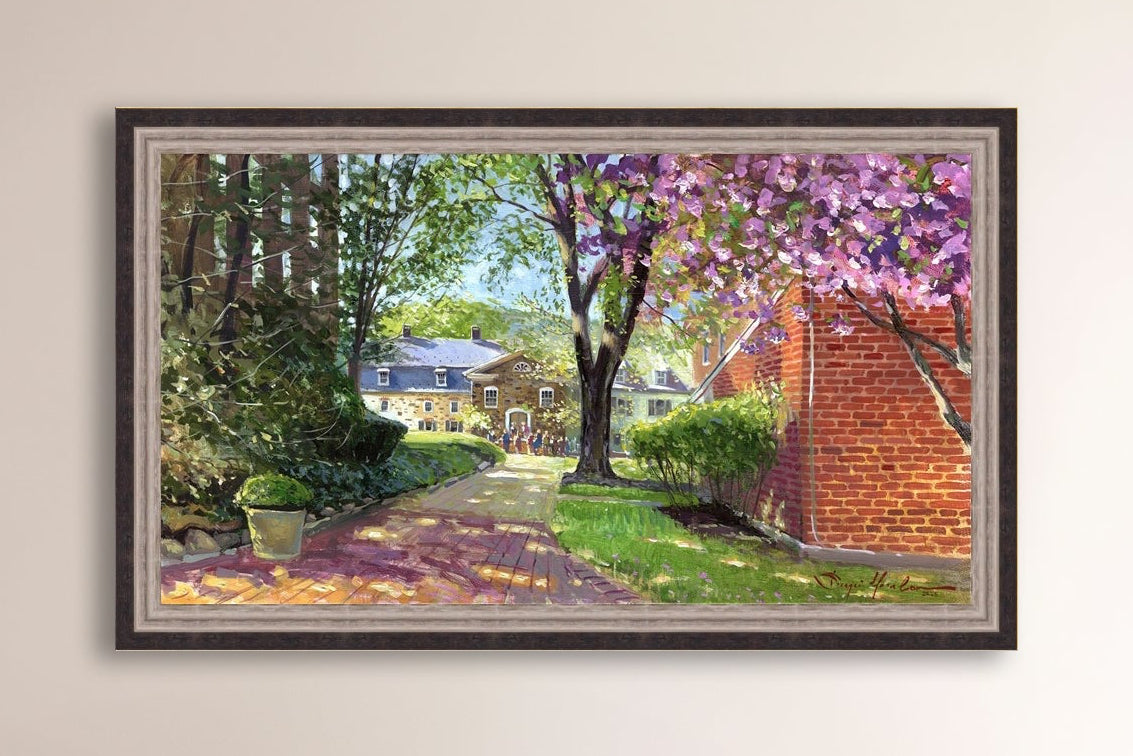 A canvas print depicting a vibrant spring scene with a pathway, trees in bloom, and a historic Moravian Chapel in the background.