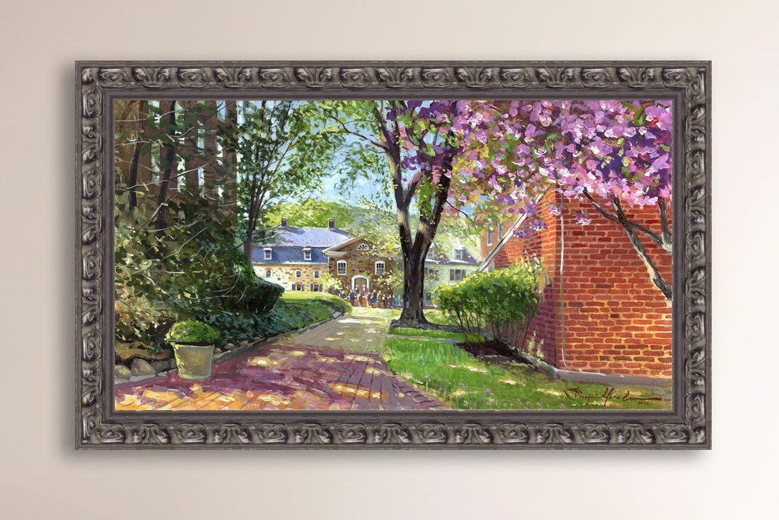 A canvas print depicting a vibrant spring scene with a pathway, trees in bloom, and a historic Moravian Chapel in the background.