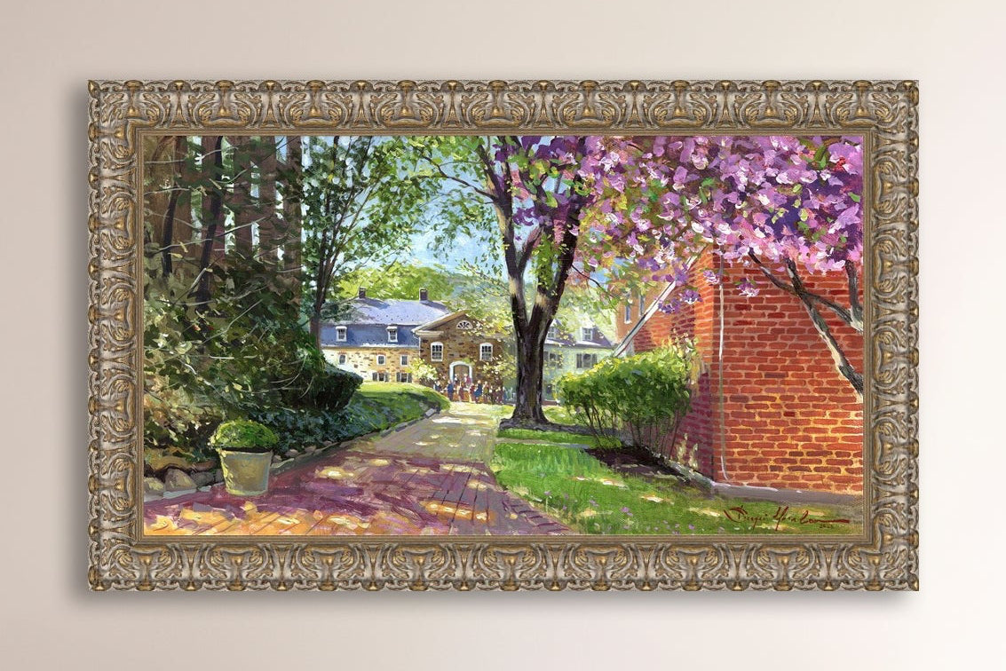 A canvas print depicting a vibrant spring scene with a pathway, trees in bloom, and a historic Moravian Chapel in the background.