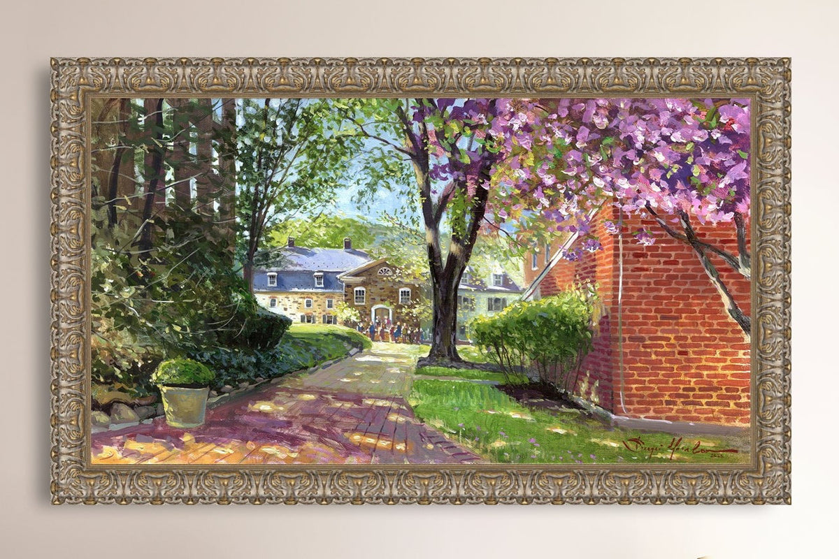 A canvas print depicting a vibrant spring scene with a pathway, trees in bloom, and a historic Moravian Chapel in the background.