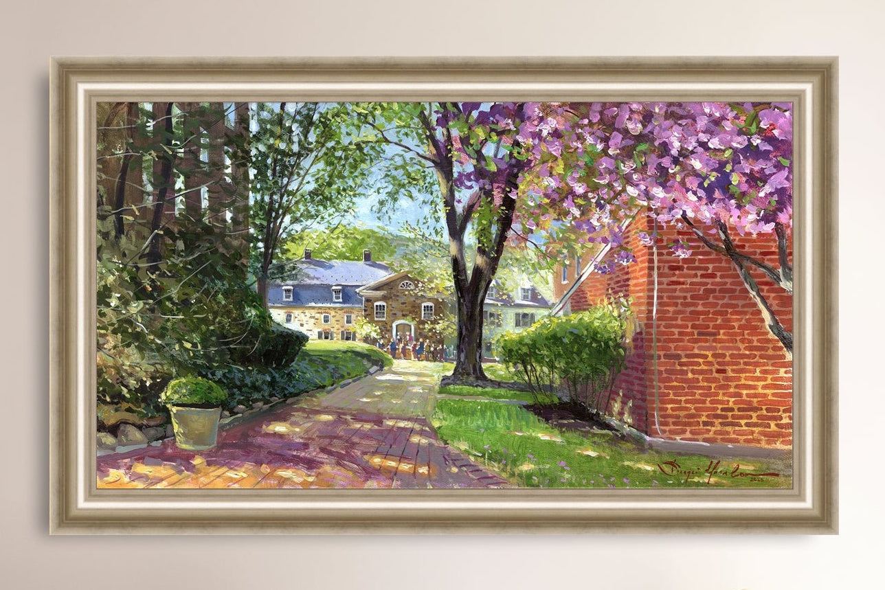 A canvas print depicting a vibrant spring scene with a pathway, trees in bloom, and a historic Moravian Chapel in the background.