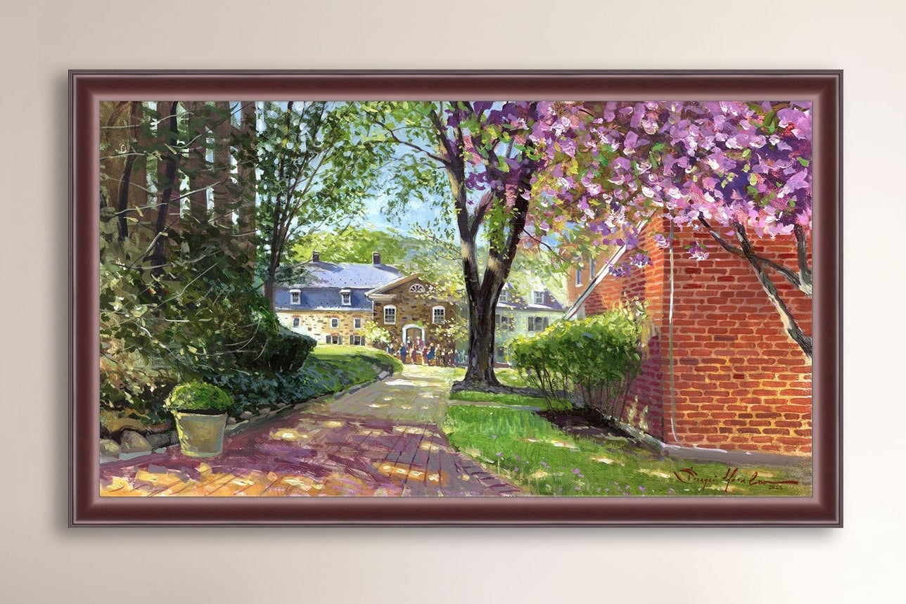 A canvas print depicting a vibrant spring scene with a pathway, trees in bloom, and a historic Moravian Chapel in the background.