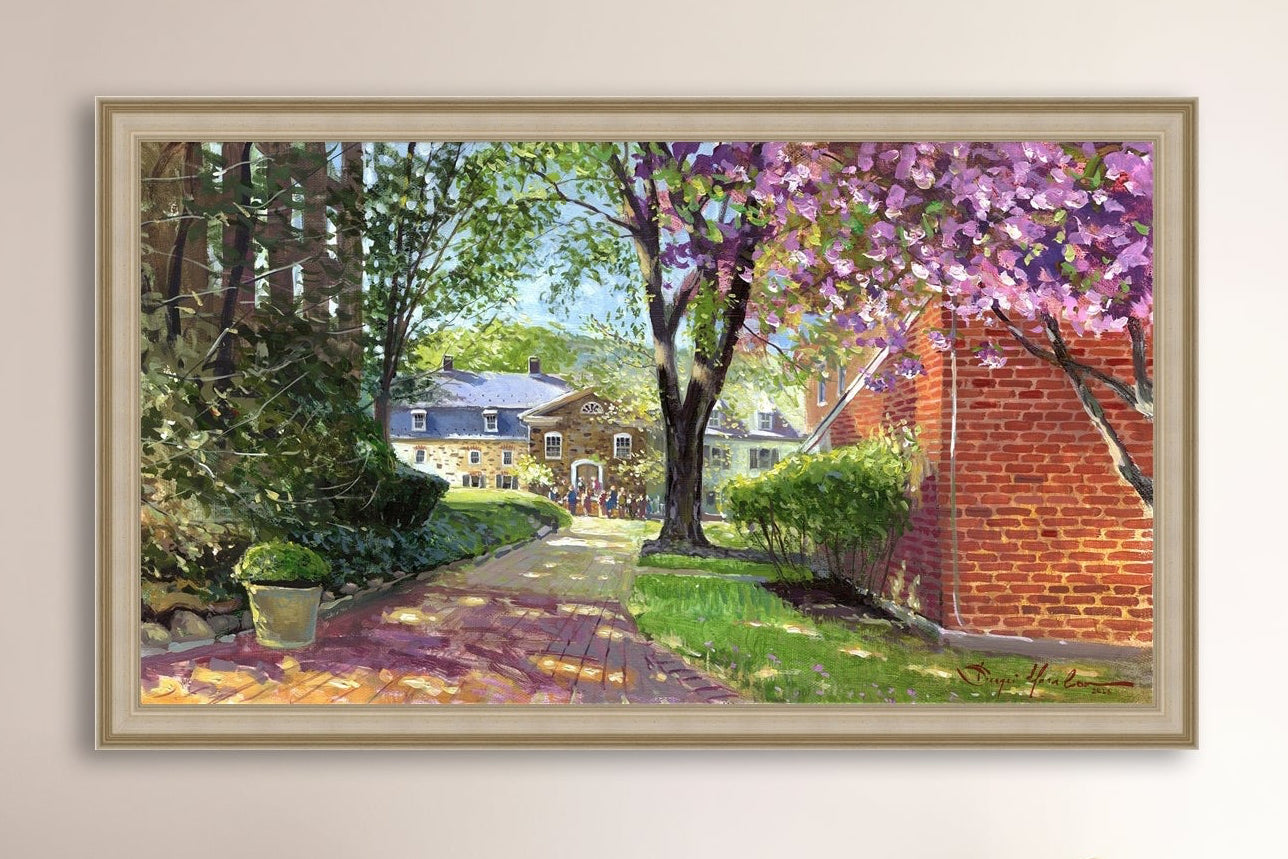 A canvas print depicting a vibrant spring scene with a pathway, trees in bloom, and a historic Moravian Chapel in the background.