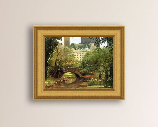 A canvas print of 'Summer in Central Park, New York' featuring bridge in the park and Plaza Hotel in the background.