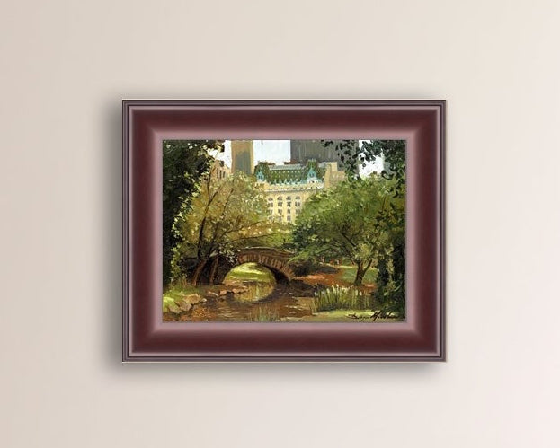 A canvas print of 'Summer in Central Park, New York' featuring bridge in the park and Plaza Hotel in the background.