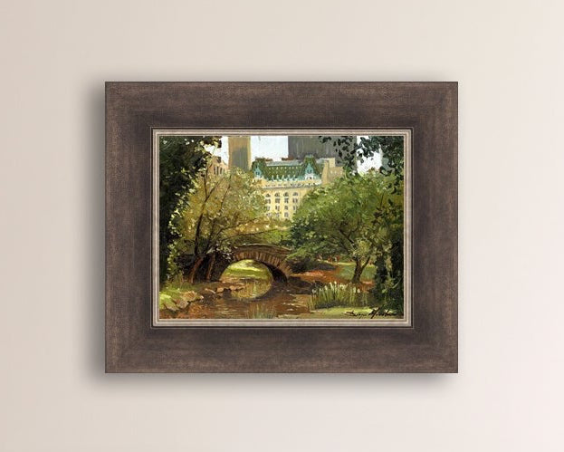 A canvas print of 'Summer in Central Park, New York' featuring bridge in the park and Plaza Hotel in the background.