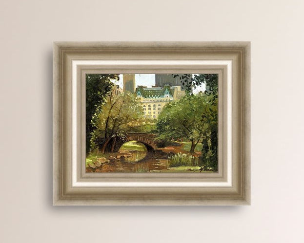 A canvas print of 'Summer in Central Park, New York' featuring bridge in the park and Plaza Hotel in the background.