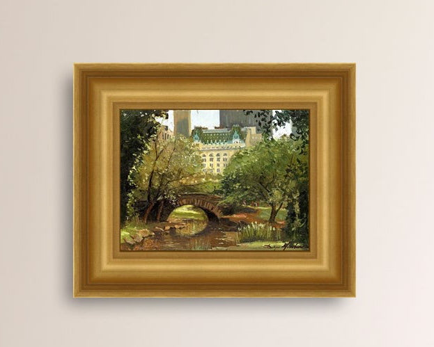 A canvas print of 'Summer in Central Park, New York' featuring bridge in the park and Plaza Hotel in the background.