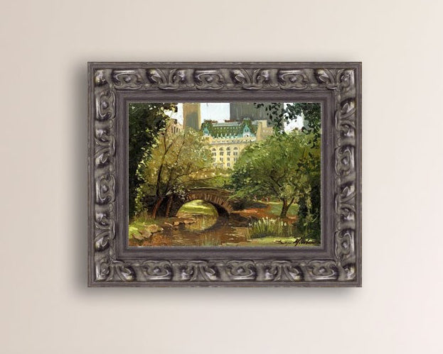 A canvas print of 'Summer in Central Park, New York' featuring bridge in the park and Plaza Hotel in the background.