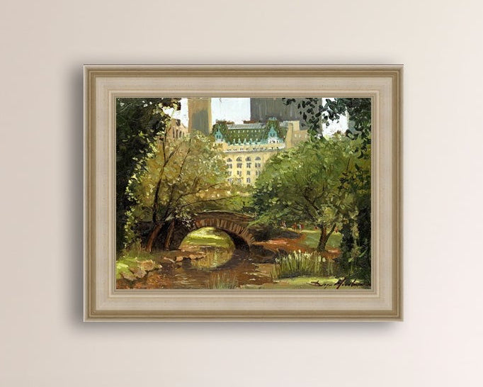 A canvas print of 'Summer in Central Park, New York' featuring bridge in the park and Plaza Hotel in the background.