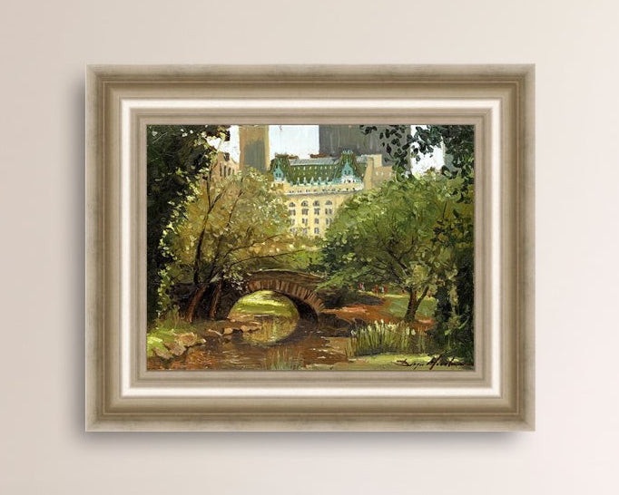 A canvas print of 'Summer in Central Park, New York' featuring bridge in the park and Plaza Hotel in the background.