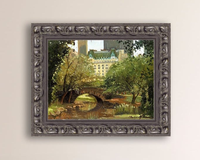 A canvas print of 'Summer in Central Park, New York' featuring bridge in the park and Plaza Hotel in the background.