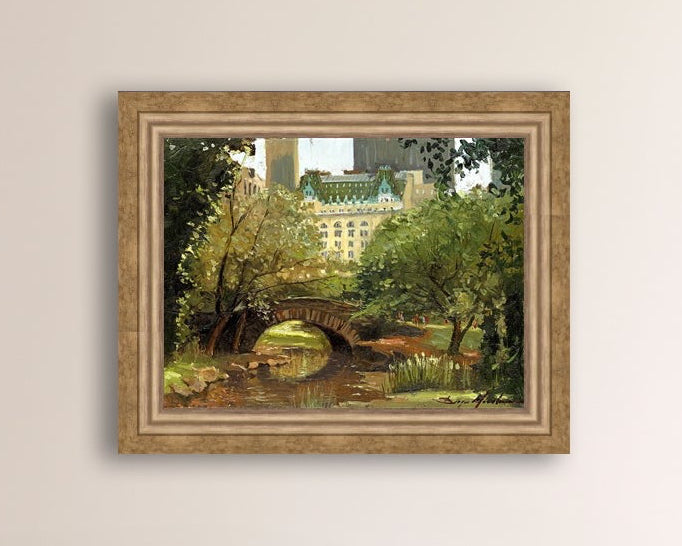 A canvas print of 'Summer in Central Park, New York' featuring bridge in the park and Plaza Hotel in the background.
